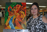 Mirna Jaber shows off one of several paintings she had on display; this piece has graced the cover of Ad Libitum
