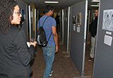 Attendees of the Art & Literary Night view works of art created by classmates, mentors and colleagues