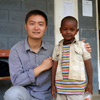 Medical student Kedong Wang with small boy at local health clinic in Hawassa