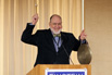 Dr. Stephen Baum sounds the gong