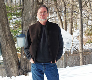 Dr. Steve Walkley on his property, tapping maple trees
