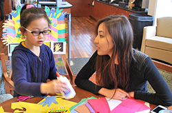Vivy Tran and a child participant doing crafts as part of an Earth Week activity