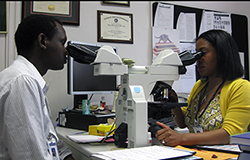 Gad Murenzi, M.D. studying pathology with his mentor Tiffany Hebert, M.D.