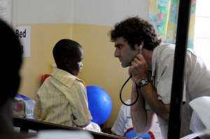 Dr. Karl Seydel (MSU and Blantyre Malaria Project) about to examine a young patient recovering from cerebral malaria on the Malaria Research Ward at Queen Elizabeth Central Hospital, Blantyre, Malawi. Picture credits to Jim Peck, Michigan State University.