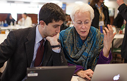  Dr. Kathryn Anastos, GHC co-director, conferring with conference attendee