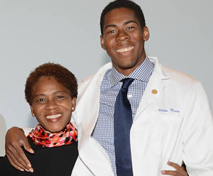 Mother and son share a moment at the White Coat Ceremony held for first-year medical students