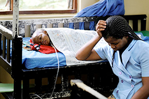 A mother and her comatose child with cerebral malaria on the Malaria Research Ward at Queen Elizabeth Central Hospital, Blantyre, Malawi.