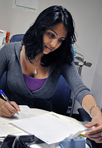 Einstein student, Priya Patel, reads a test result