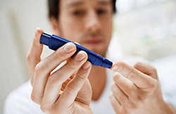A patient with diabetes obtains blood for measuring his blood glucose level. Research at Einstein may help people learn they’re at risk for diabetes long before it occurs.